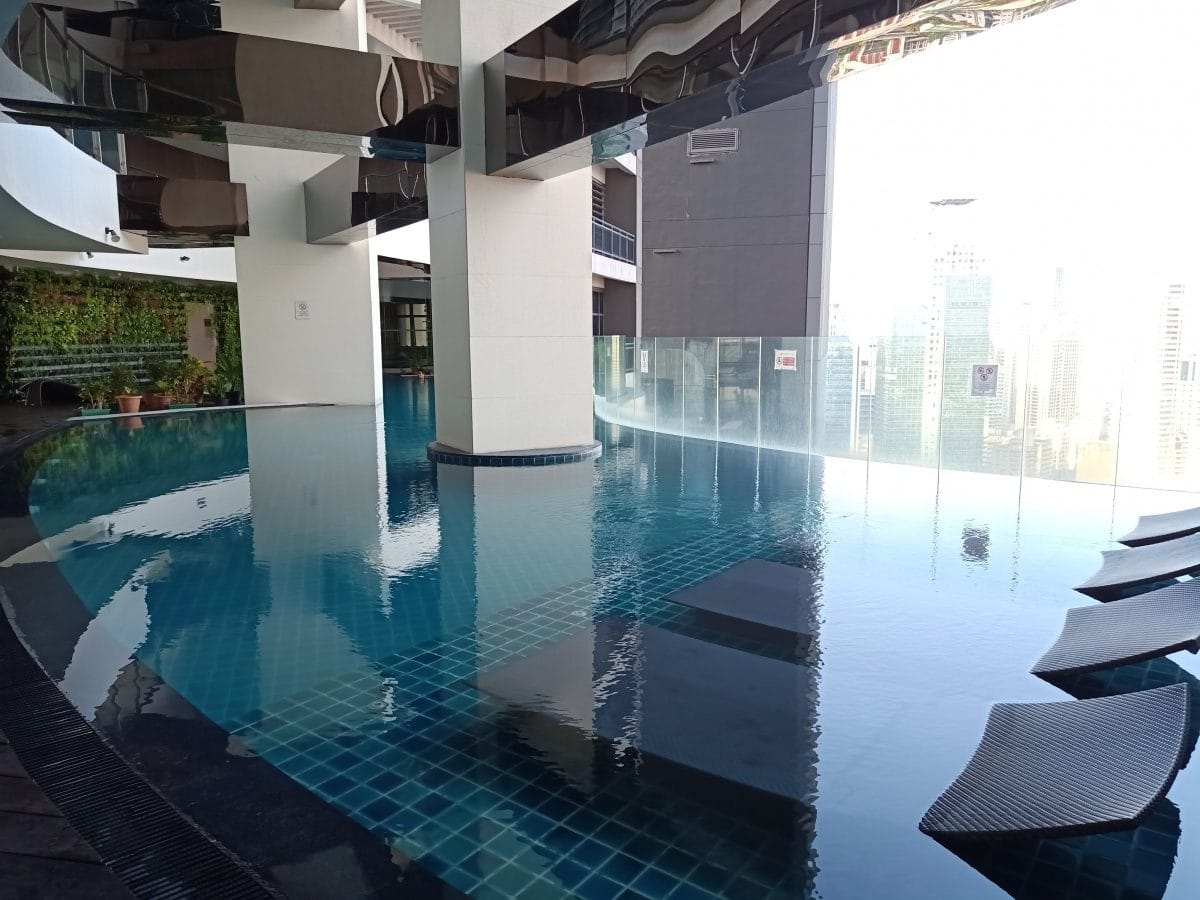 ALT="gramercy residences zen rooms and the stunning view of the pool"