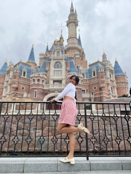 shanghai disneyland castle behind the girl